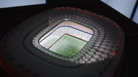 Miniature football stadium lit up in the dark